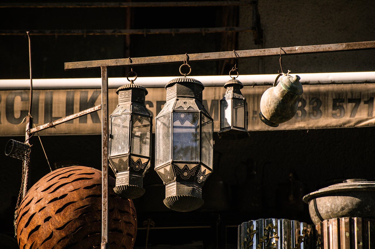 Traditional Ottoman-style lanterns hanging outdoors in Istanbul, showcasing rustic metal designs.
